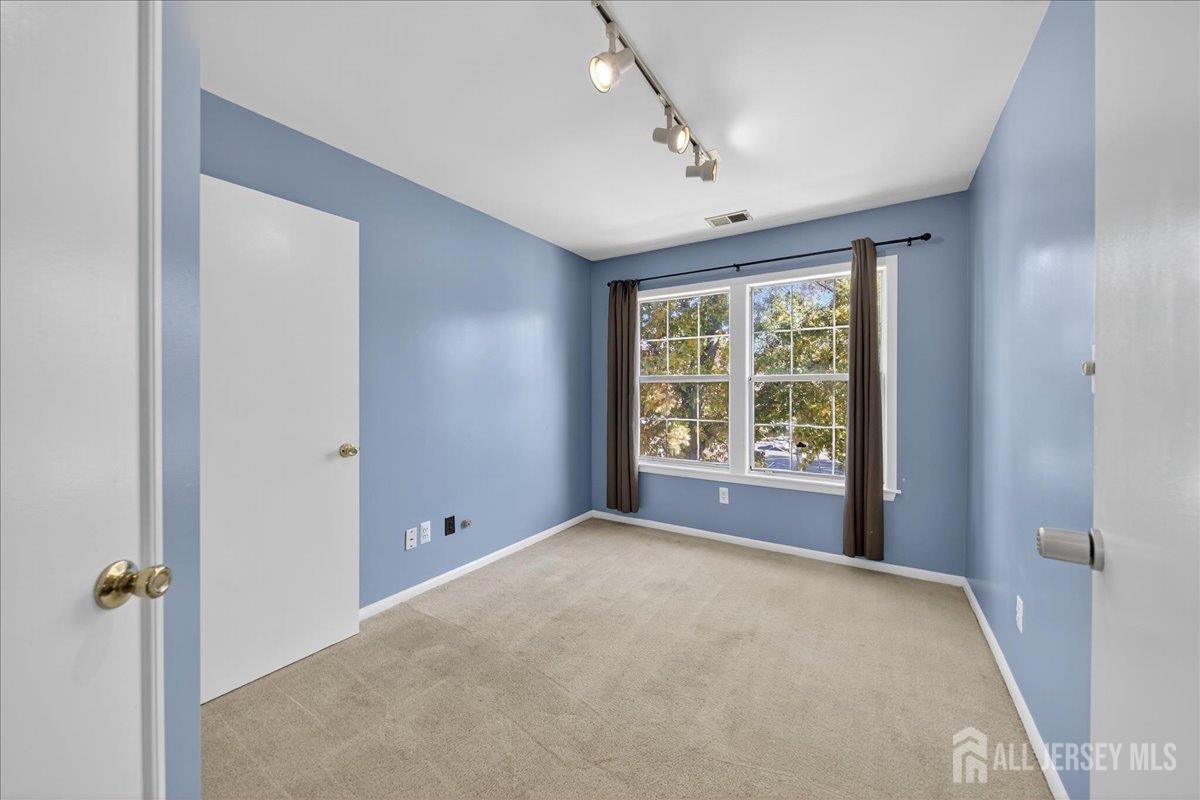 306 Trinity Court, Unit 12 Princeton, NJ 08540 - Photo 8 of 26 a view of an empty room with a window