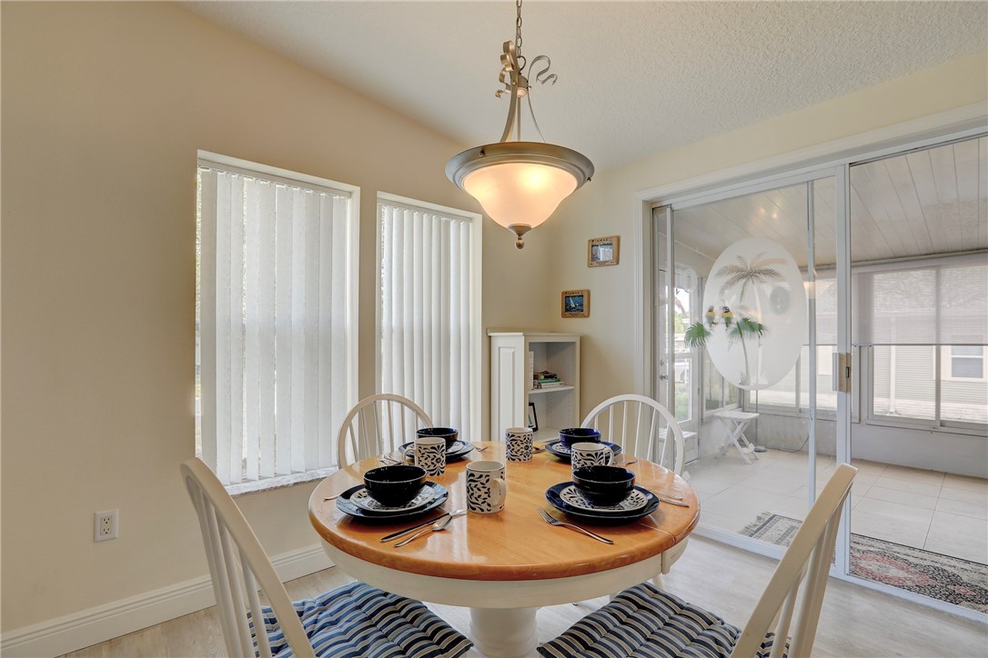 362 Egret Circle Barefoot Bay, FL 32976 - Photo 15 of 36 a view of a dining room with furniture and chandelier