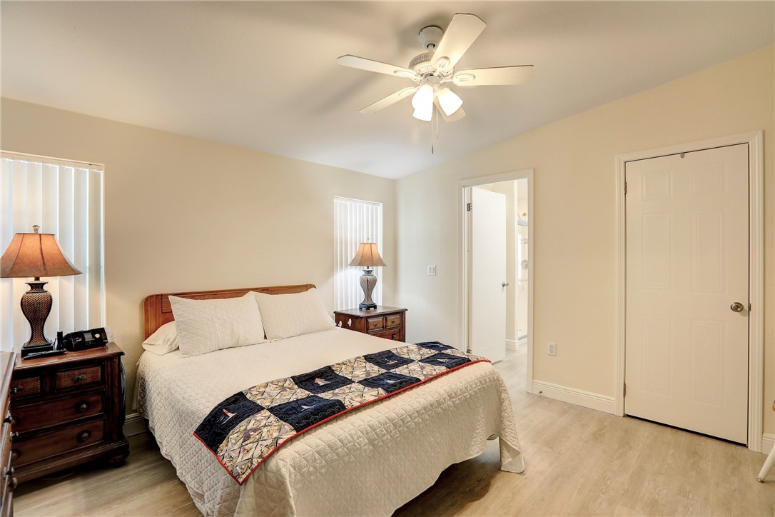362 Egret Circle Barefoot Bay, FL 32976 - Photo 16 of 36 a bedroom with a bed and a chandelier