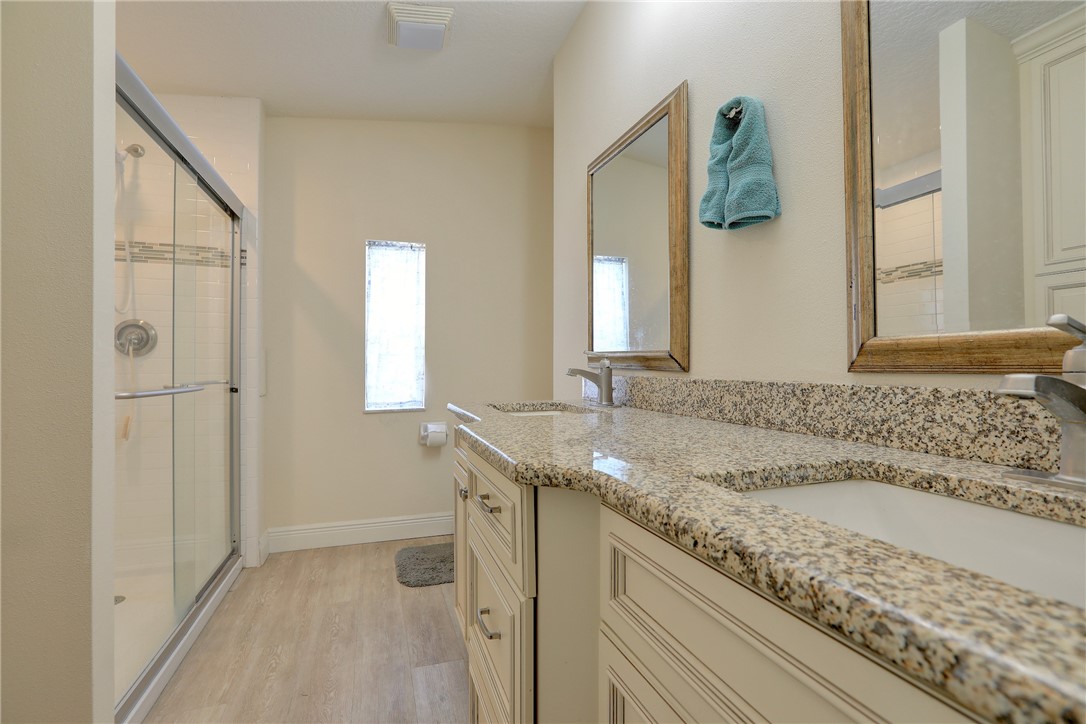 362 Egret Circle Barefoot Bay, FL 32976 - Photo 18 of 36 a bathroom with a granite countertop sink and a mirror