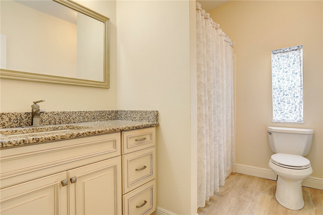 362 Egret Circle Barefoot Bay, FL 32976 - Photo 21 of 36 a bathroom with a granite countertop toilet sink and mirror