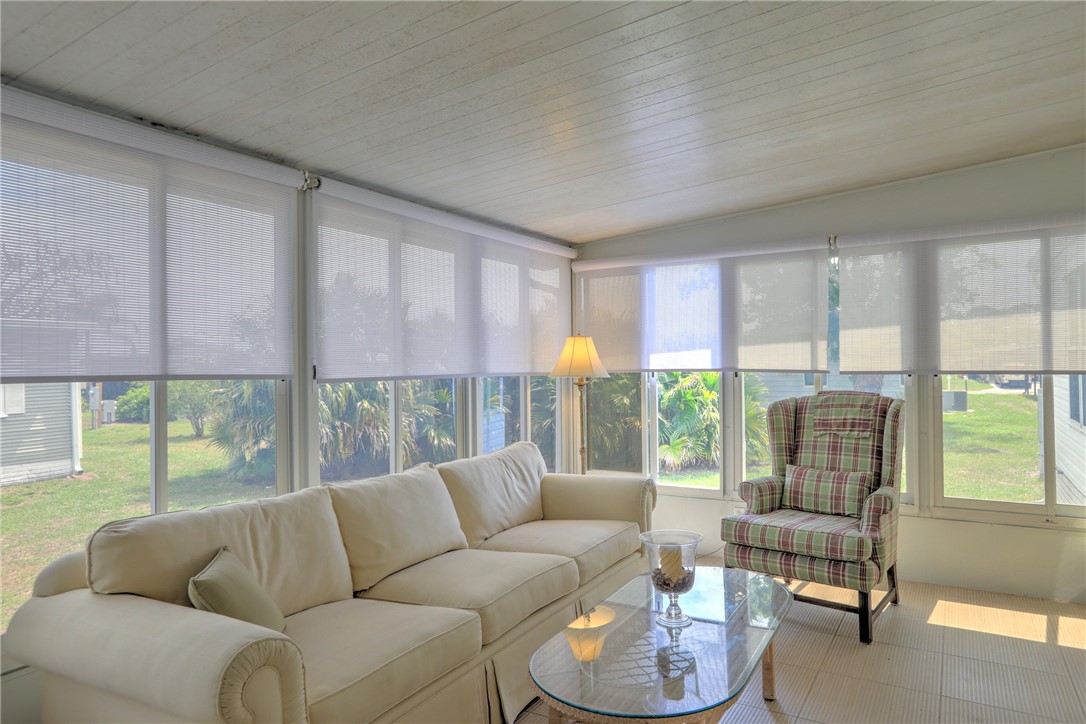 362 Egret Circle Barefoot Bay, FL 32976 - Photo 9 of 36 a living room with furniture and a large window