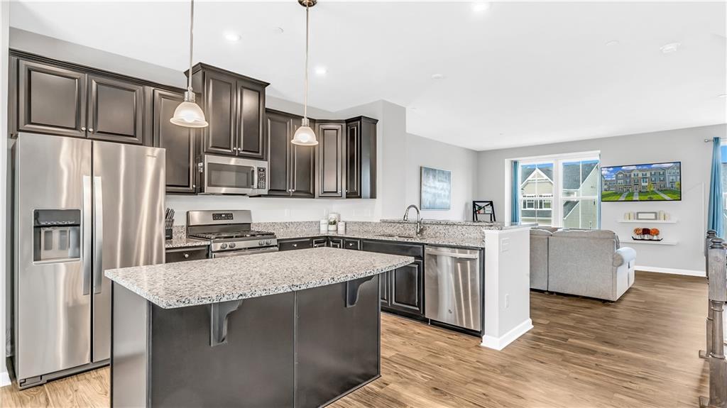 4204 Spruce Road Gibsonia, PA 15044 - Photo 2 of 22 a kitchen with stainless steel appliances granite countertop a sink stove and refrigerator