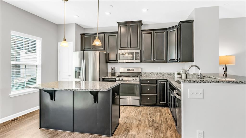 4204 Spruce Road Gibsonia, PA 15044 - Photo 3 of 22 a kitchen with stainless steel appliances granite countertop a stove a sink dishwasher a refrigerator and a microwave