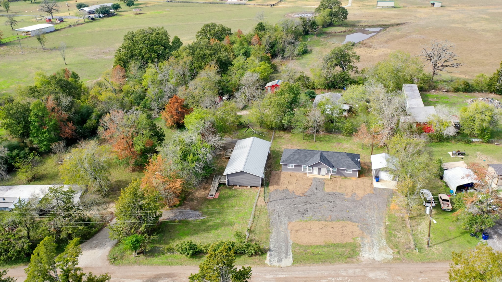 an aerial view of a house with a yard basket ball court and outdoor seating
