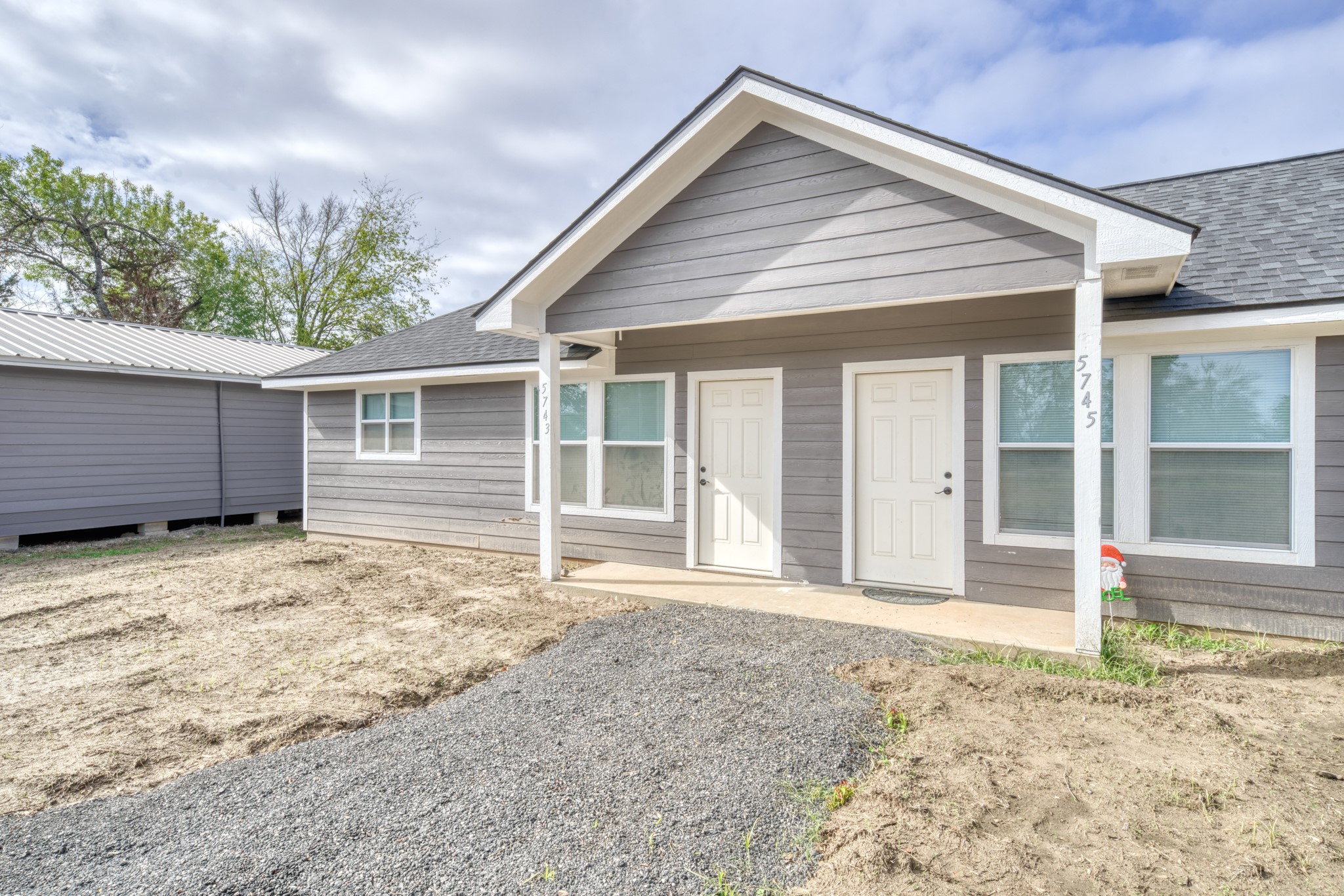 9337 Ash Street Midway, TX 75852 - Photo 21 of 28 a front view of a house with a yard and garage