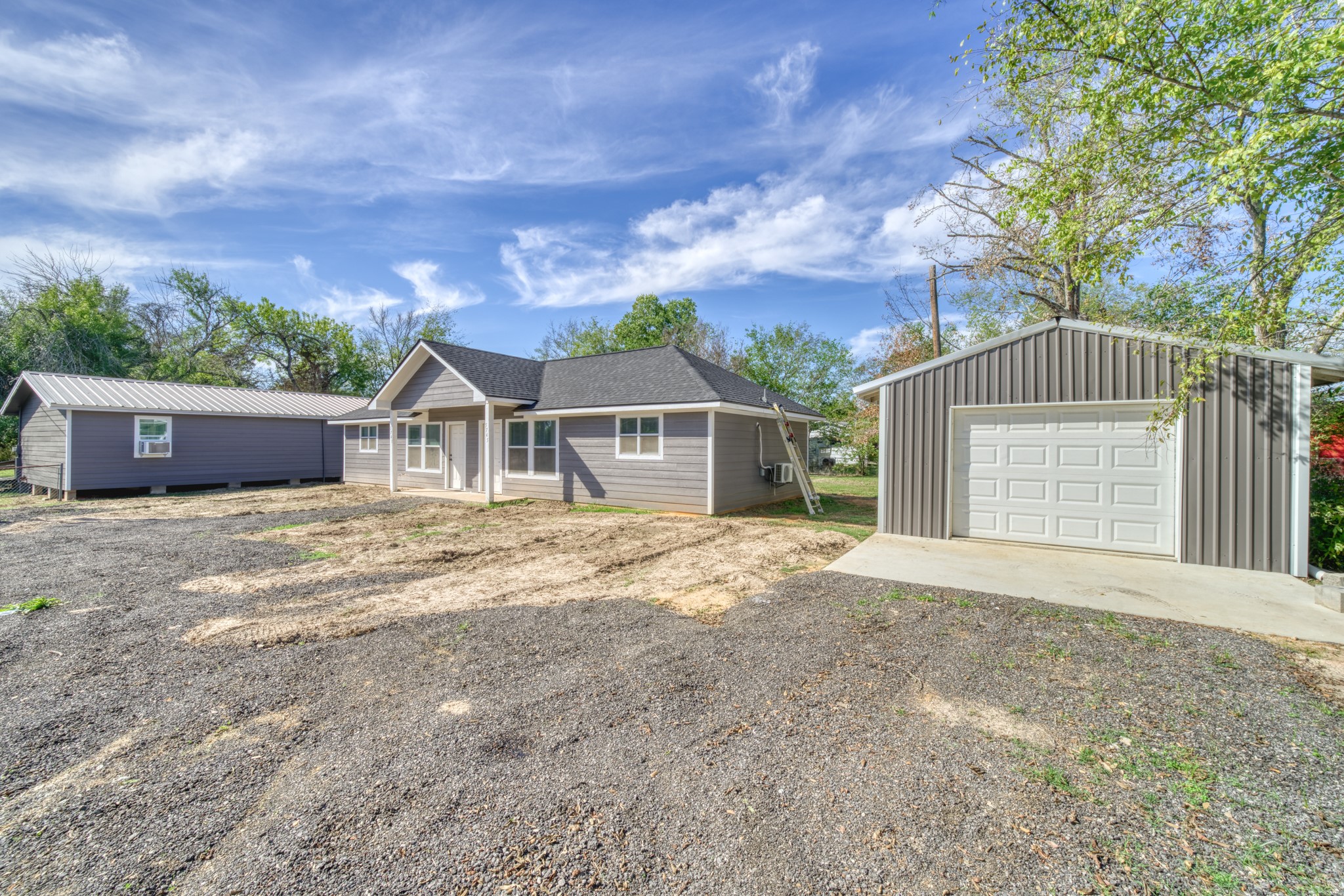9337 Ash Street Midway, TX 75852 - Photo 3 of 28 a front view of a house with a garden and trees