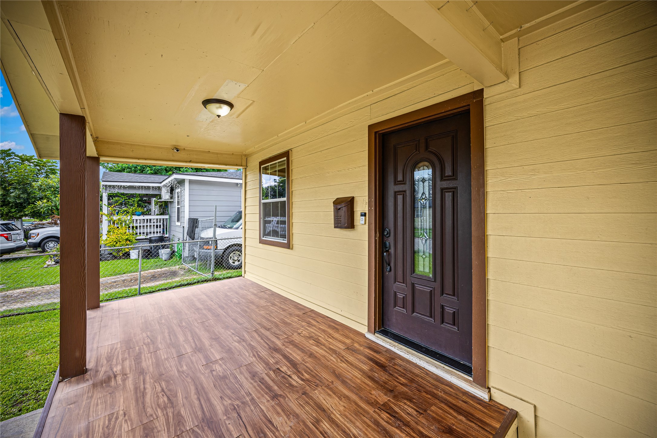 10221 Flaxman Street Houston, TX 77029 - Photo 3 of 20 a view of a porch with wooden floor and a yard
