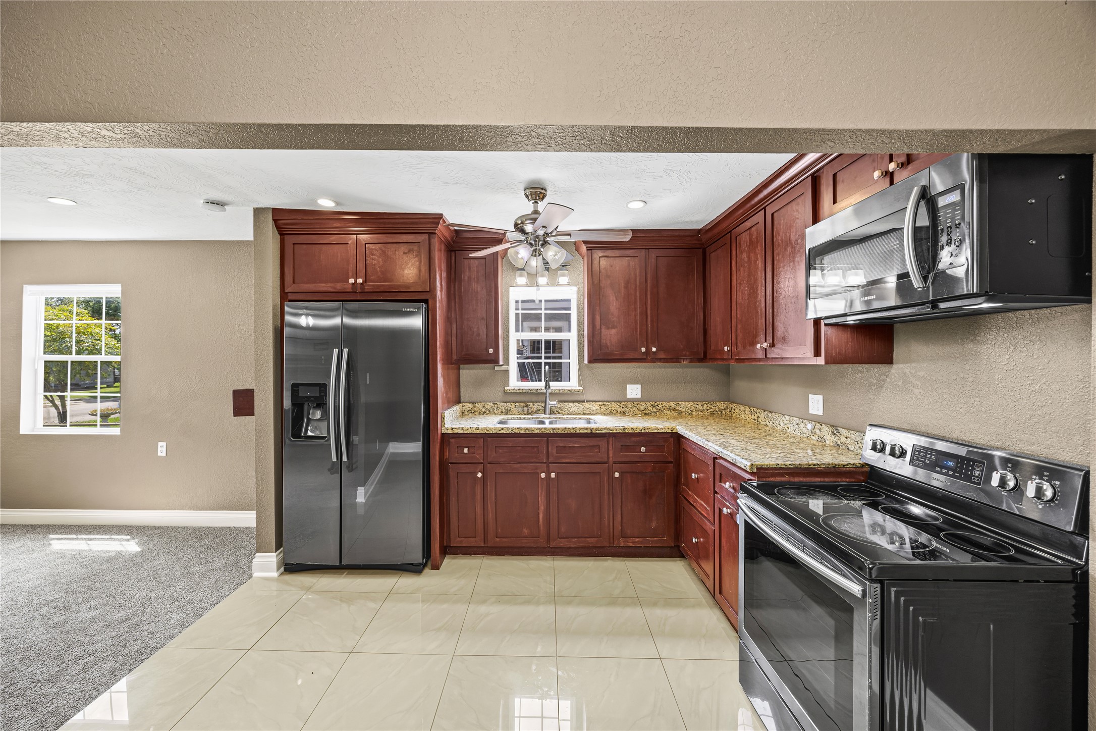10221 Flaxman Street Houston, TX 77029 - Photo 7 of 20 a kitchen with stainless steel appliances granite countertop a stove a sink and a microwave