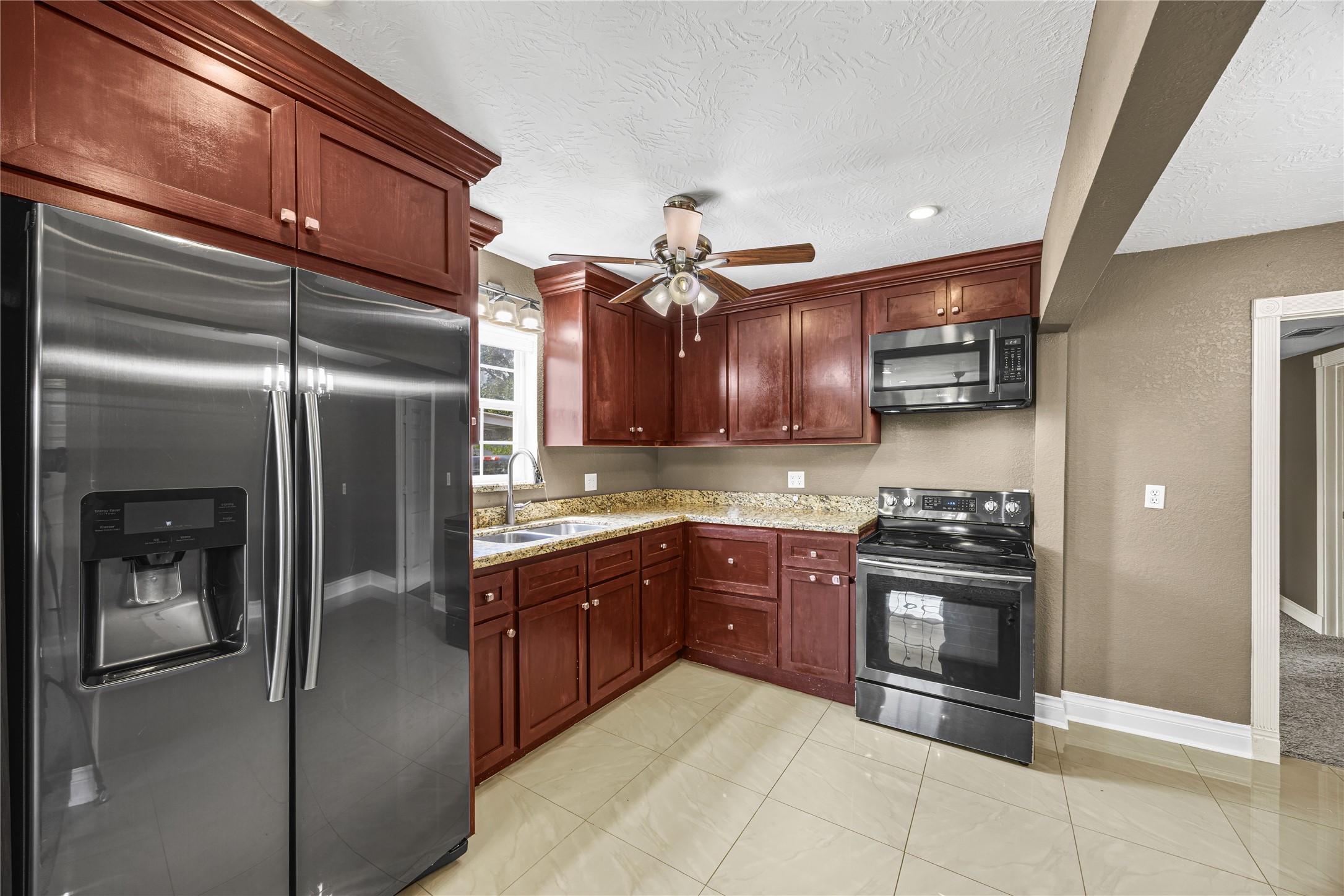10221 Flaxman Street Houston, TX 77029 - Photo 8 of 20 a kitchen with stainless steel appliances granite countertop a refrigerator a stove and a sink