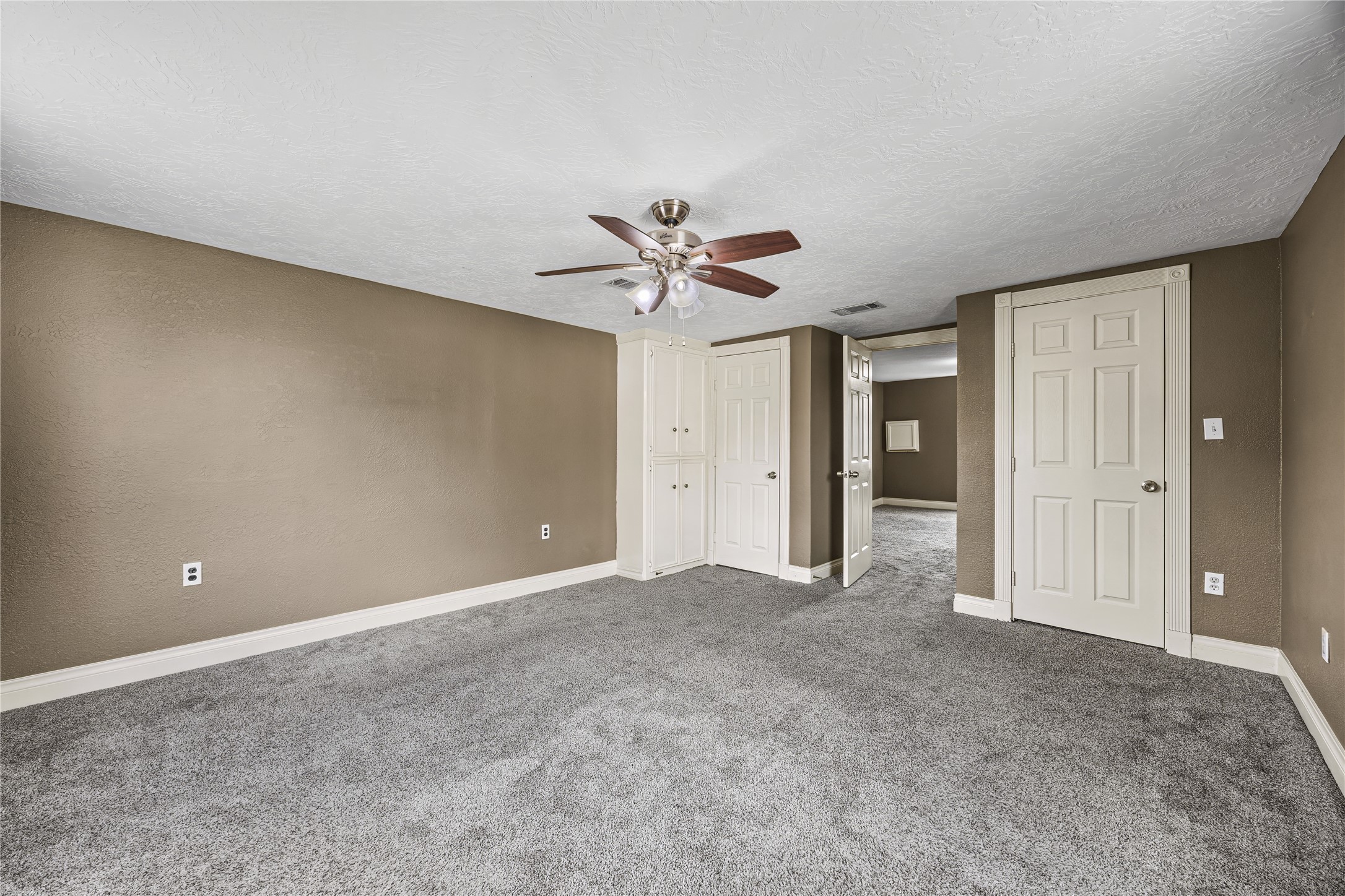 10221 Flaxman Street Houston, TX 77029 - Photo 9 of 20 a view of an empty room with a ceiling fan