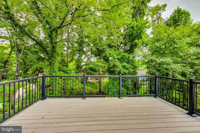 a view of a balcony with wooden floor and fence