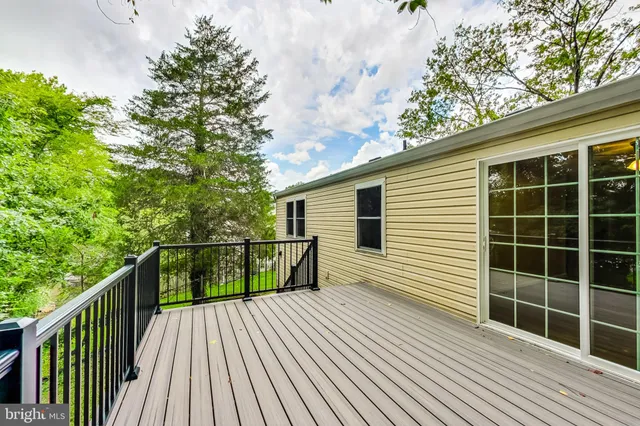 a view of balcony with wooden floor and fence
