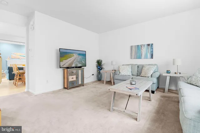 a living room with furniture and a painting on the wall