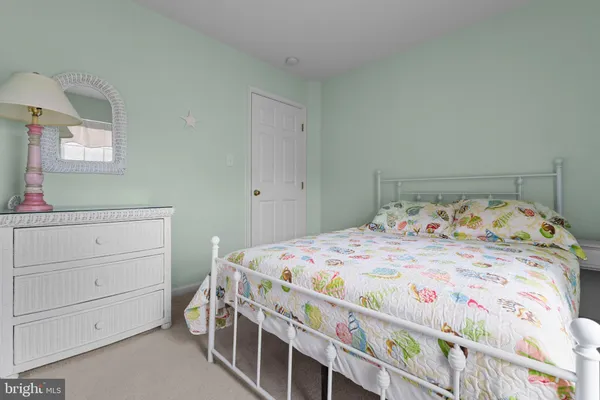 a bedroom with a bed and a dresser in it