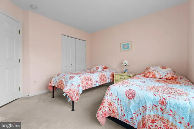 a bedroom with two beds and painted wall