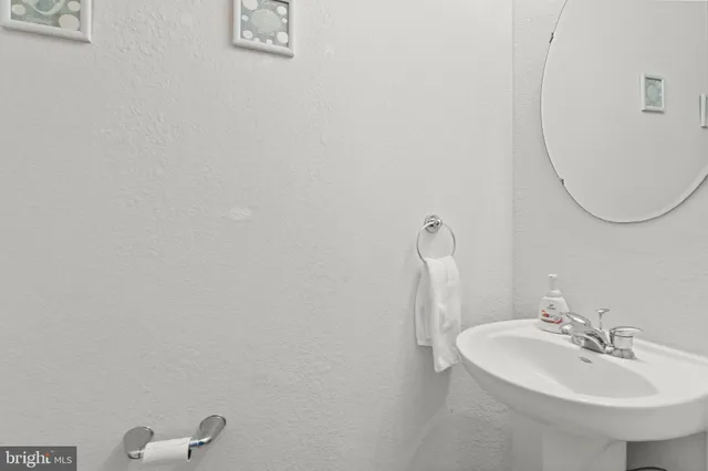 a bathroom with a sink and mirror