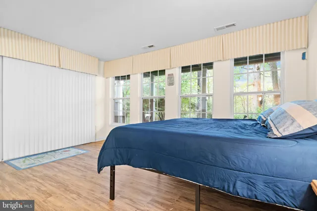 a bedroom with a bed and window