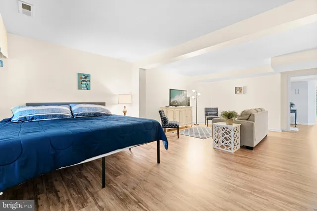 a spacious bedroom with a bed and a couch