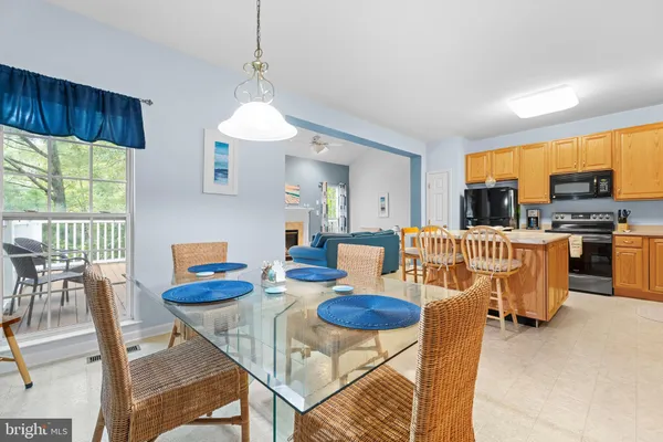 a outdoor kitchen with dining table and chairs