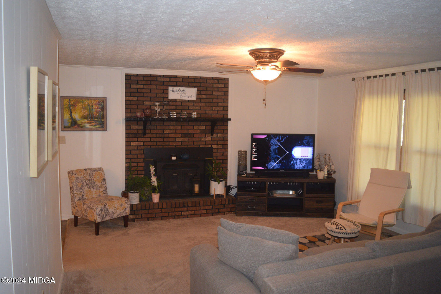 891 Walker Road Byron, GA 31008 - Photo 2 of 24 a living room with furniture a fireplace and a flat screen tv