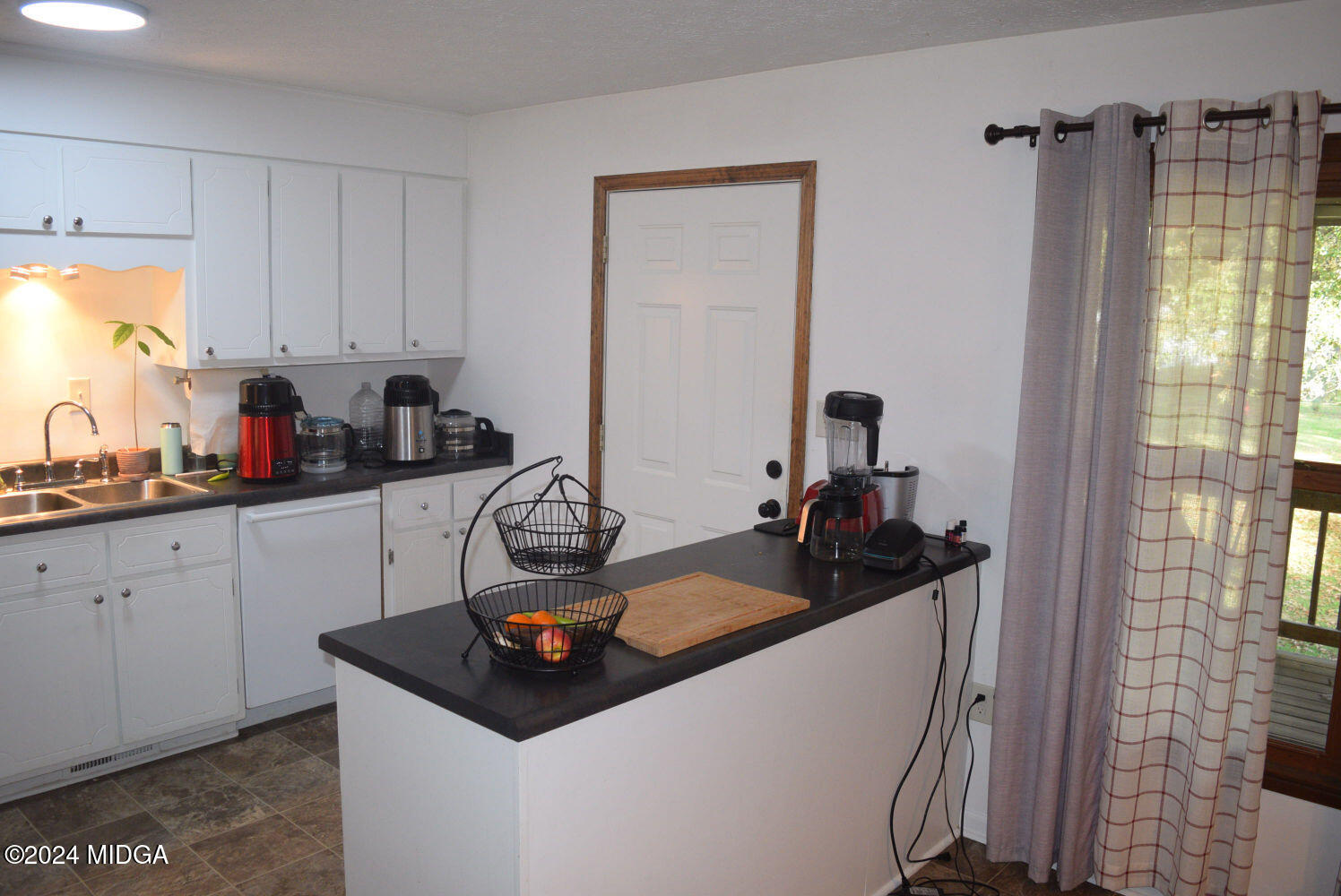 891 Walker Road Byron, GA 31008 - Photo 5 of 24 a kitchen with a refrigerator and a stove top oven
