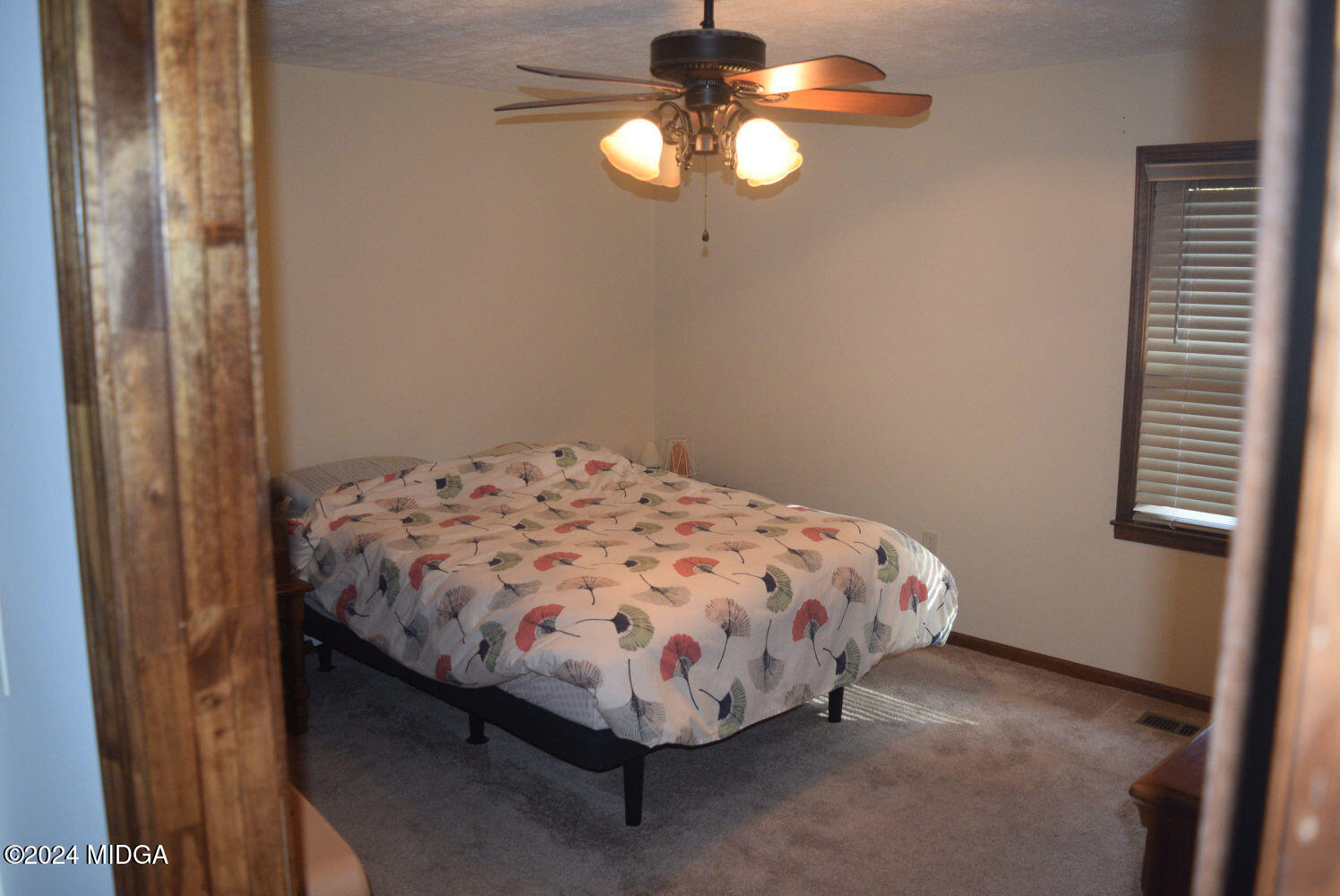 891 Walker Road Byron, GA 31008 - Photo 9 of 24 a bed sitting in a bedroom next to a window