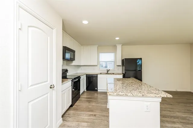a kitchen with a sink stove and refrigerator