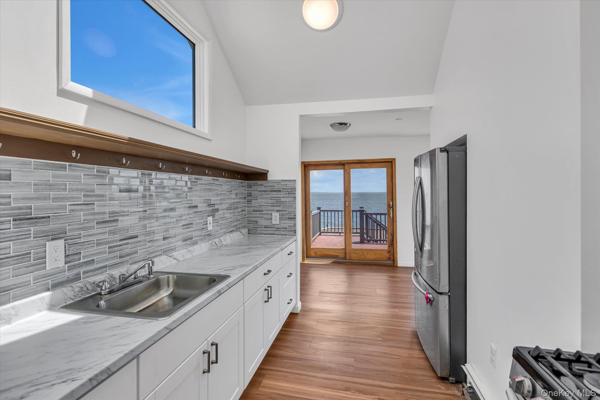 24 Milton Road Babylon, NY 11702 - Photo 4 of 30 a kitchen with granite countertop a sink and a refrigerator