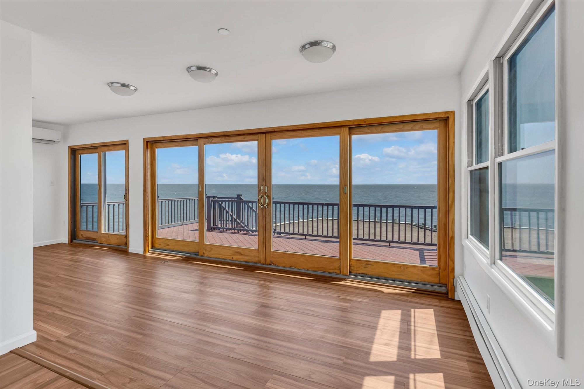 24 Milton Road Babylon, NY 11702 - Photo 7 of 30 wooden floor in an empty room with a window