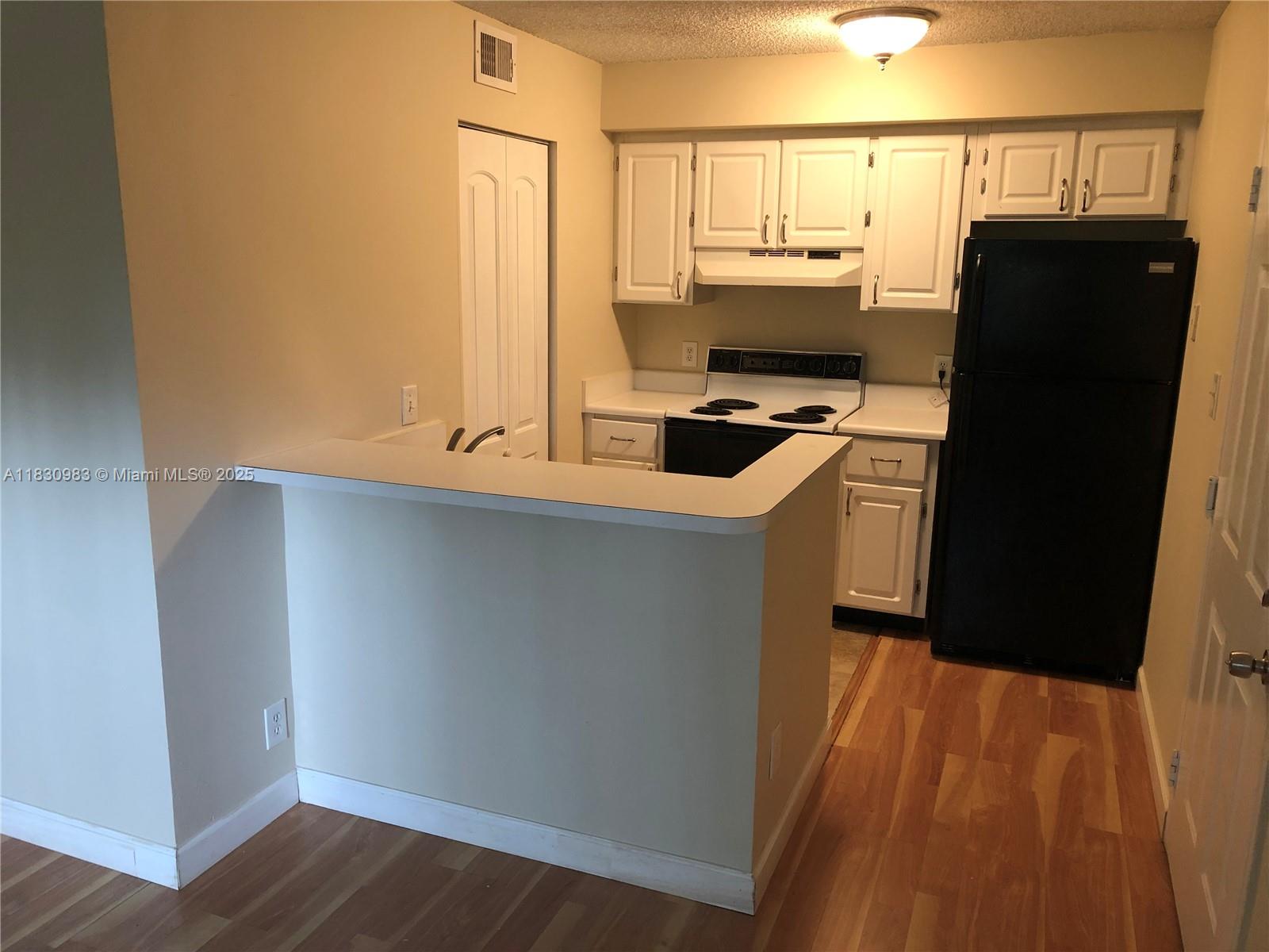 620 South Park Road, Unit 332 Hollywood, FL 33021 - Photo 3 of 6 a kitchen with stainless steel appliances a refrigerator and a stove