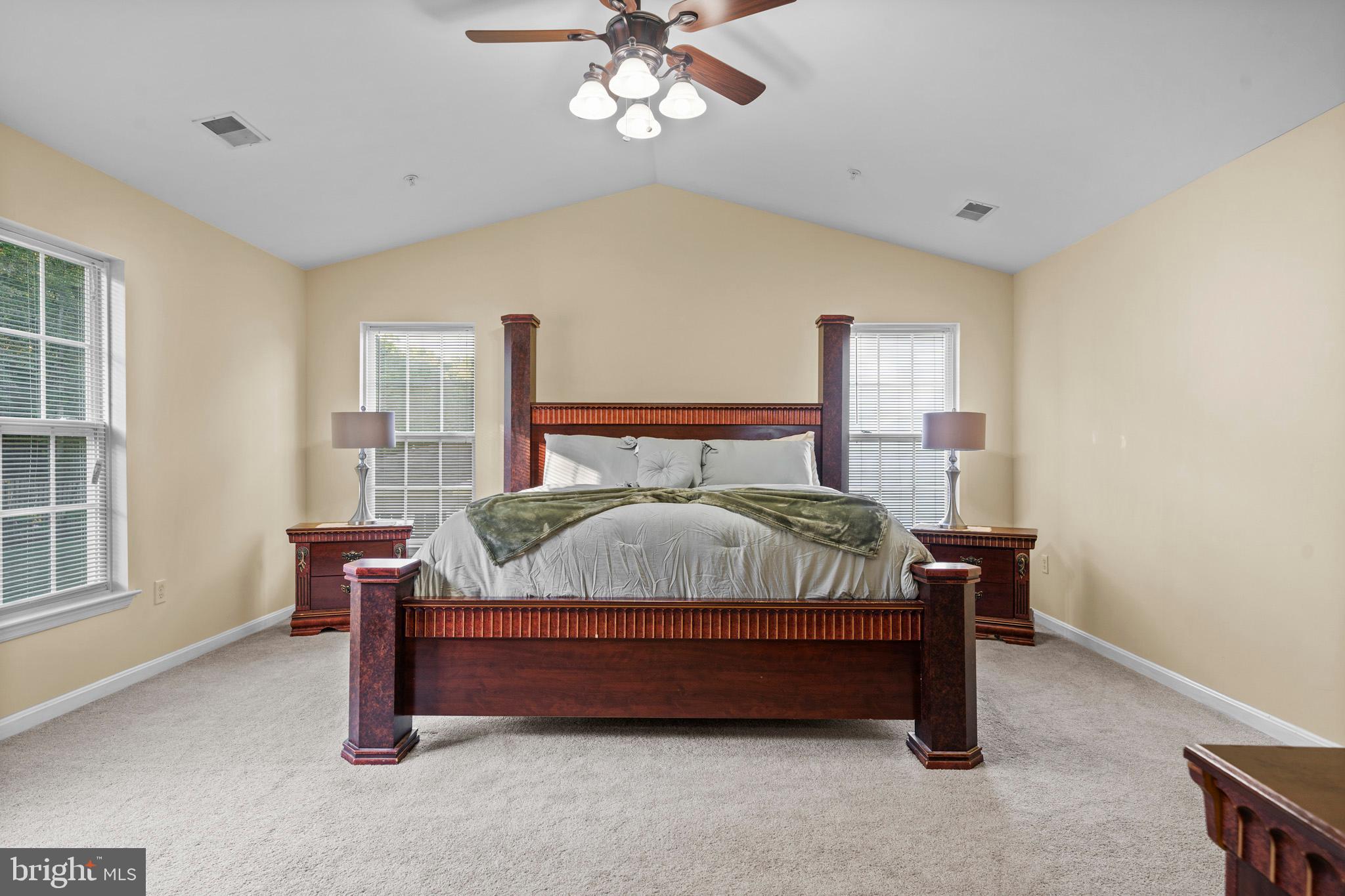 6514 Manton Way Lanham, MD 20706 - Photo 12 of 24 a bedroom with a bed and windows