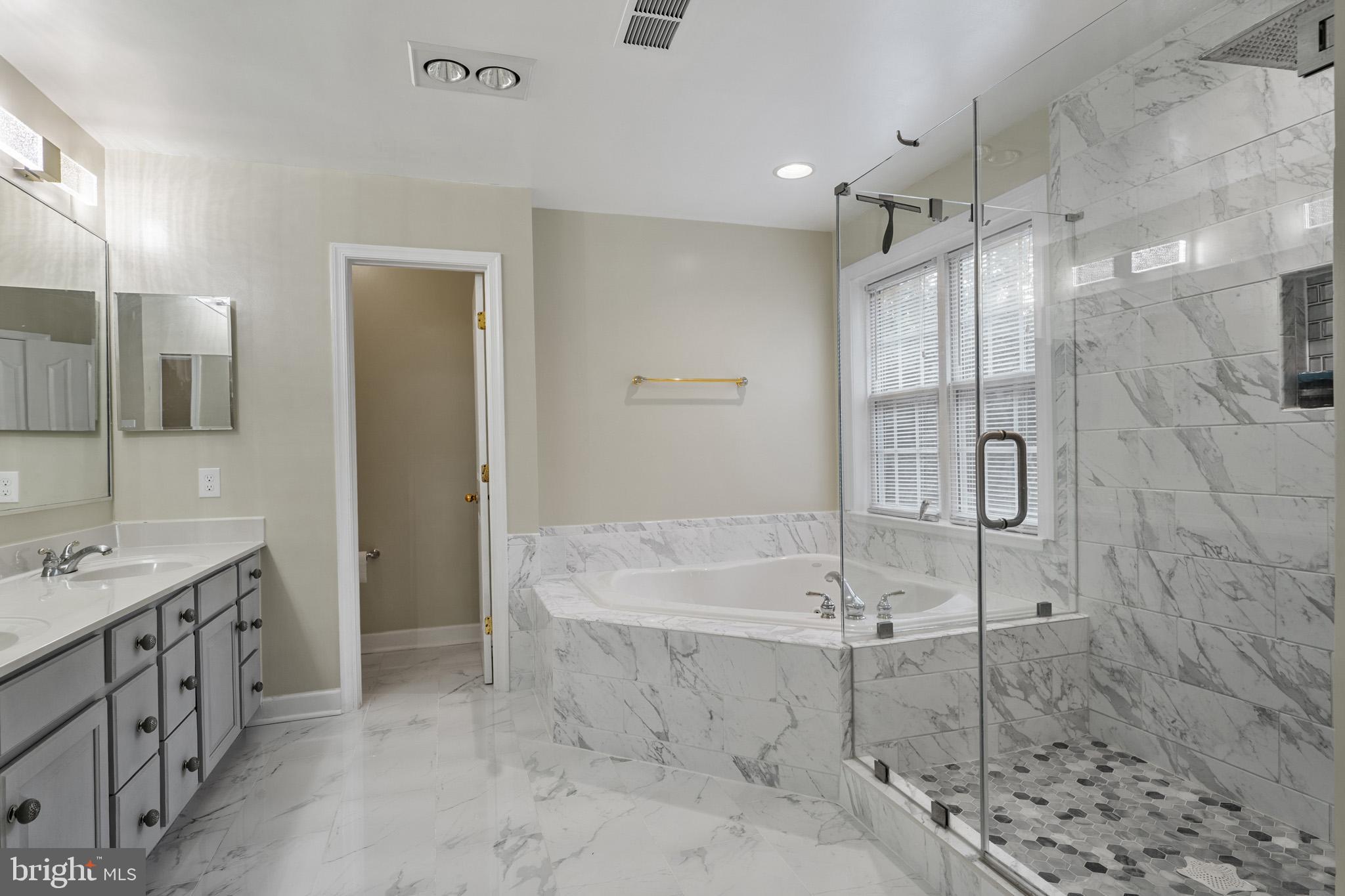 6514 Manton Way Lanham, MD 20706 - Photo 13 of 24 a bathroom with a sink and mirror