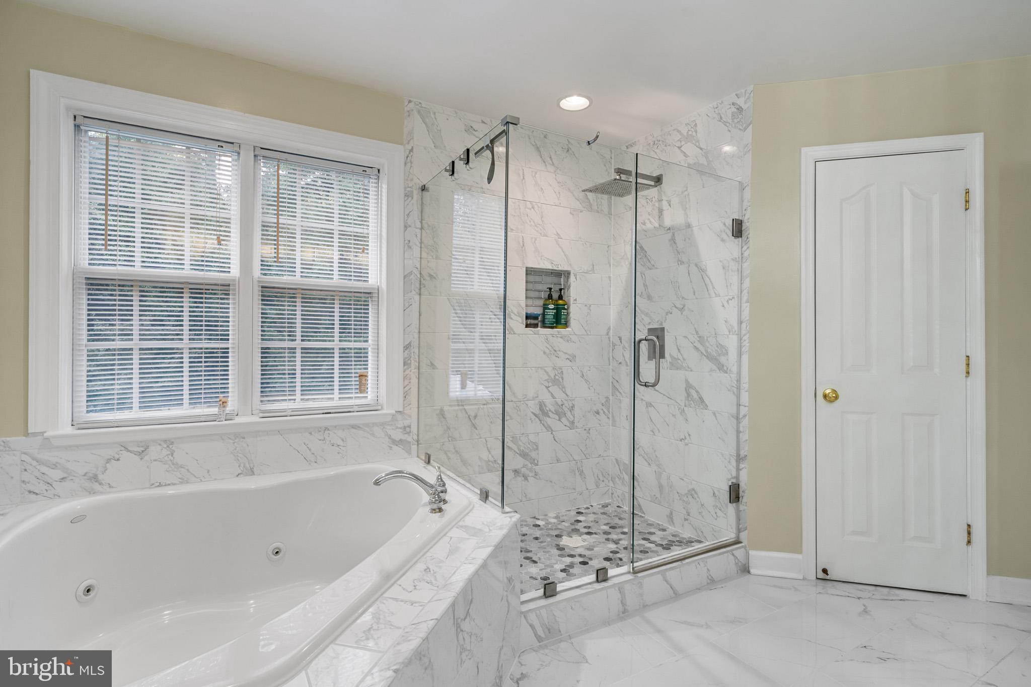 6514 Manton Way Lanham, MD 20706 - Photo 14 of 24 a bathroom with a bathtub and a shower