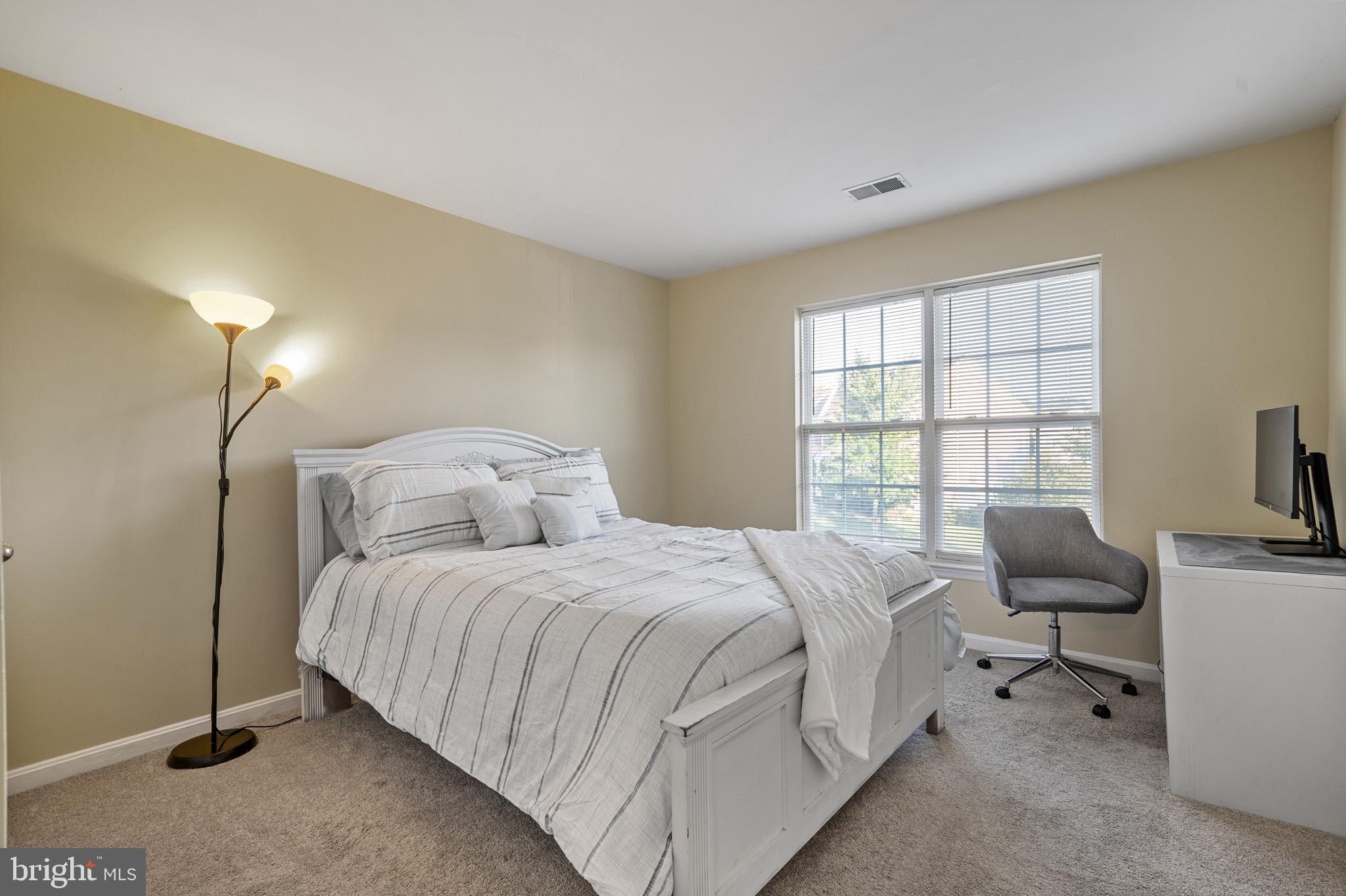 6514 Manton Way Lanham, MD 20706 - Photo 15 of 24 a bedroom with a bed and a couch