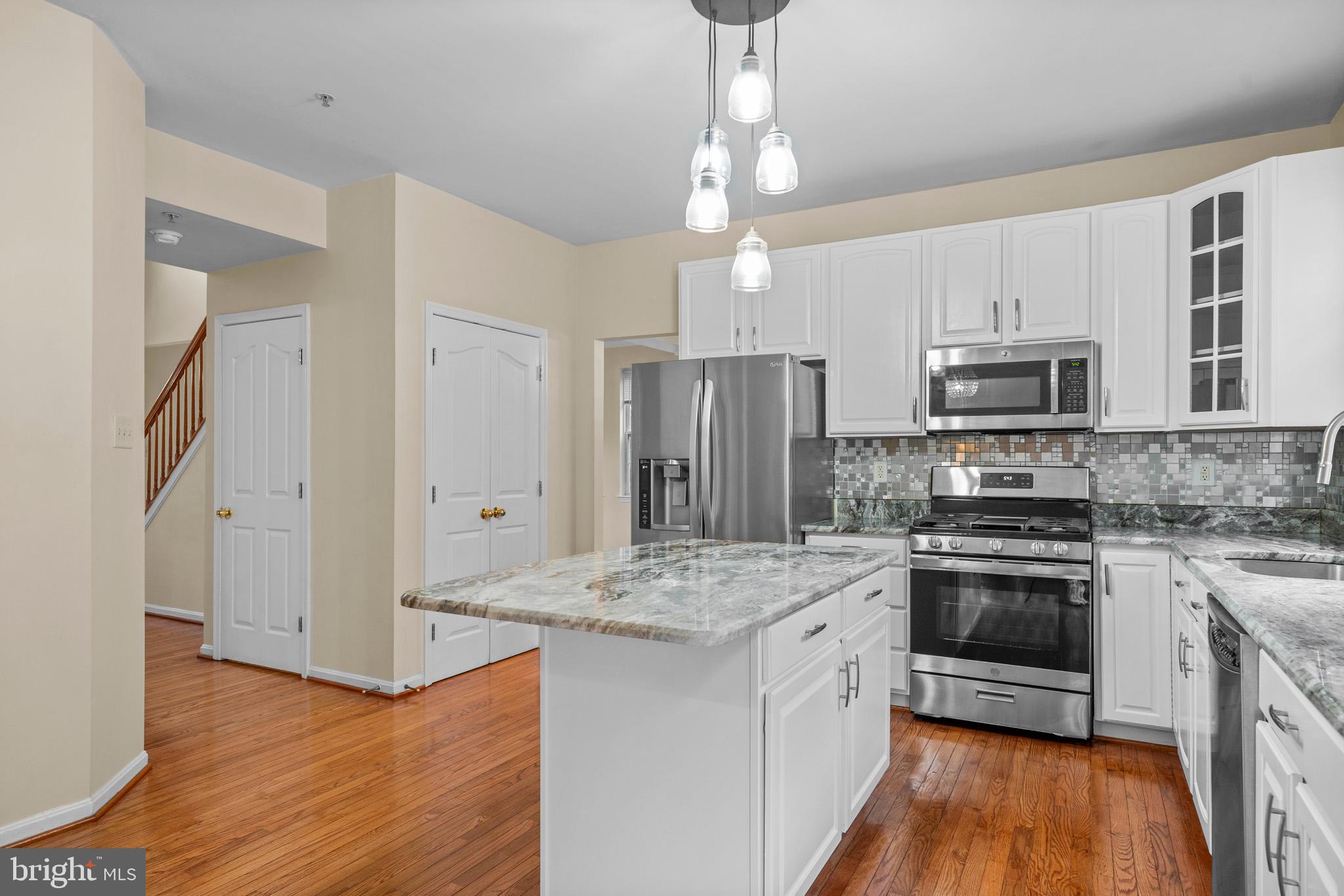 6514 Manton Way Lanham, MD 20706 - Photo 9 of 24 a kitchen with stainless steel appliances granite countertop a stove and a refrigerator