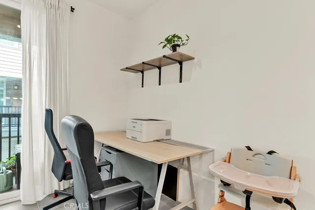 a view of workspace filled with furniture and wooden floor