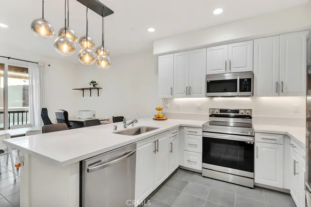 a kitchen with a stove cabinets and stainless steel appliances