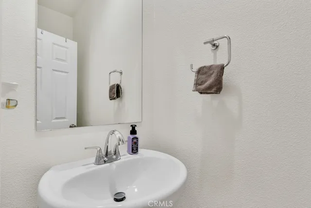a bedroom with a bed and a flat tv screen on the dresser