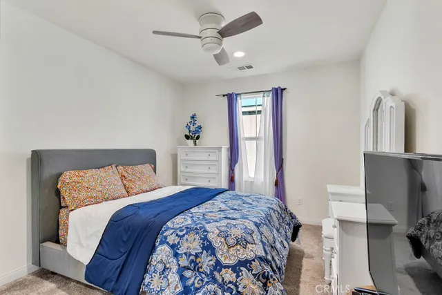 a bedroom with a large bed and a couch