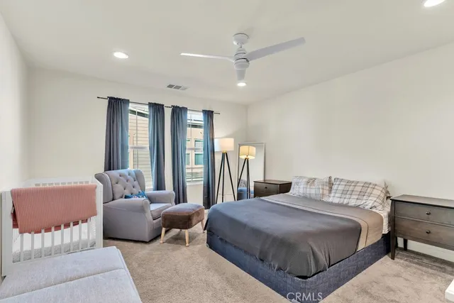 a spacious bedroom with a bed and furniture