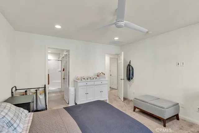 a bedroom with a bed and a mirror