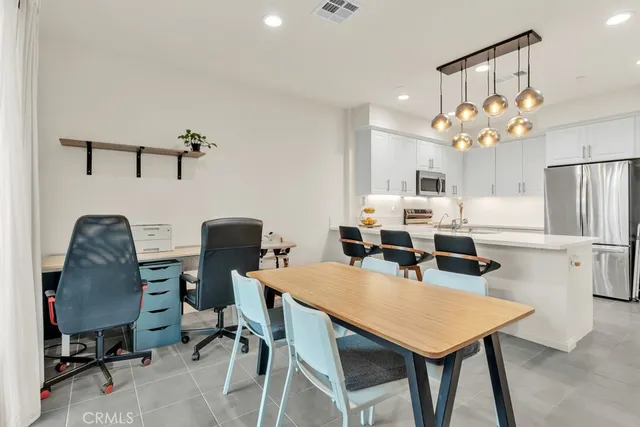 a view of a dining room with furniture and a chandelier