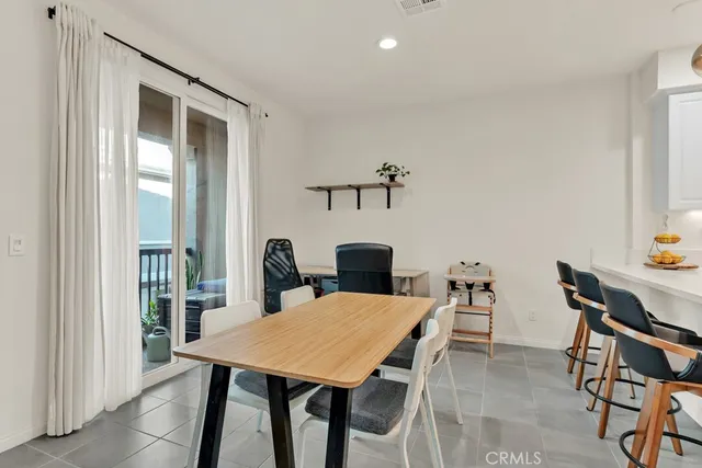 a view of a dining room with furniture and window