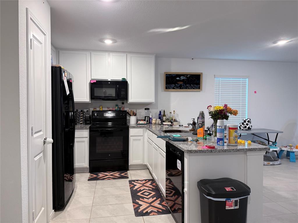 330 Ashbrook Way Princeton, TX 75407 - Photo 4 of 11 a kitchen with stainless steel appliances a stove refrigerator and a sink