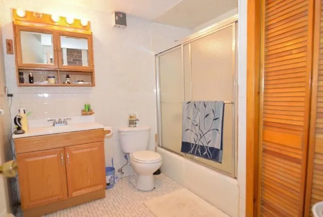 a bathroom with a toilet sink and shower