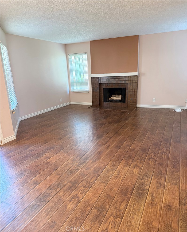 1766 Sinaloa Road, Unit 177 Simi Valley, CA 93065 - Photo 4 of 12 wooden floor fireplace and natural light in room