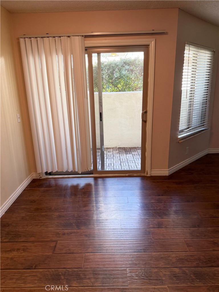 1766 Sinaloa Road, Unit 177 Simi Valley, CA 93065 - Photo 6 of 12 a view of an empty room with wooden floor and a window