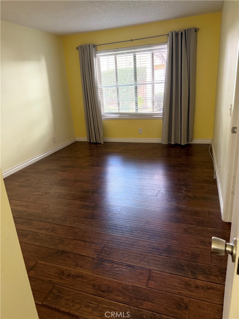 1766 Sinaloa Road, Unit 177 Simi Valley, CA 93065 - Photo 9 of 12 a view of room with window and wooden floor