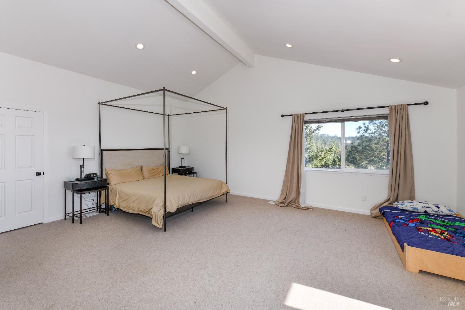 540 Edgemont Lane Angwin, CA 94508 - Photo 22 of 40 a bedroom with a bed and large window